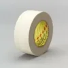 Roll of white adhesive tape on gray background.
