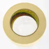 Roll of beige adhesive tape on white background.