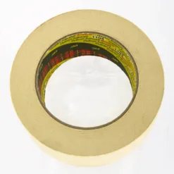 Roll of beige adhesive tape on white background.
