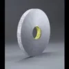 Roll of industrial adhesive tape on gray background.
