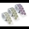 Three rolls of round adhesive dots, various colors