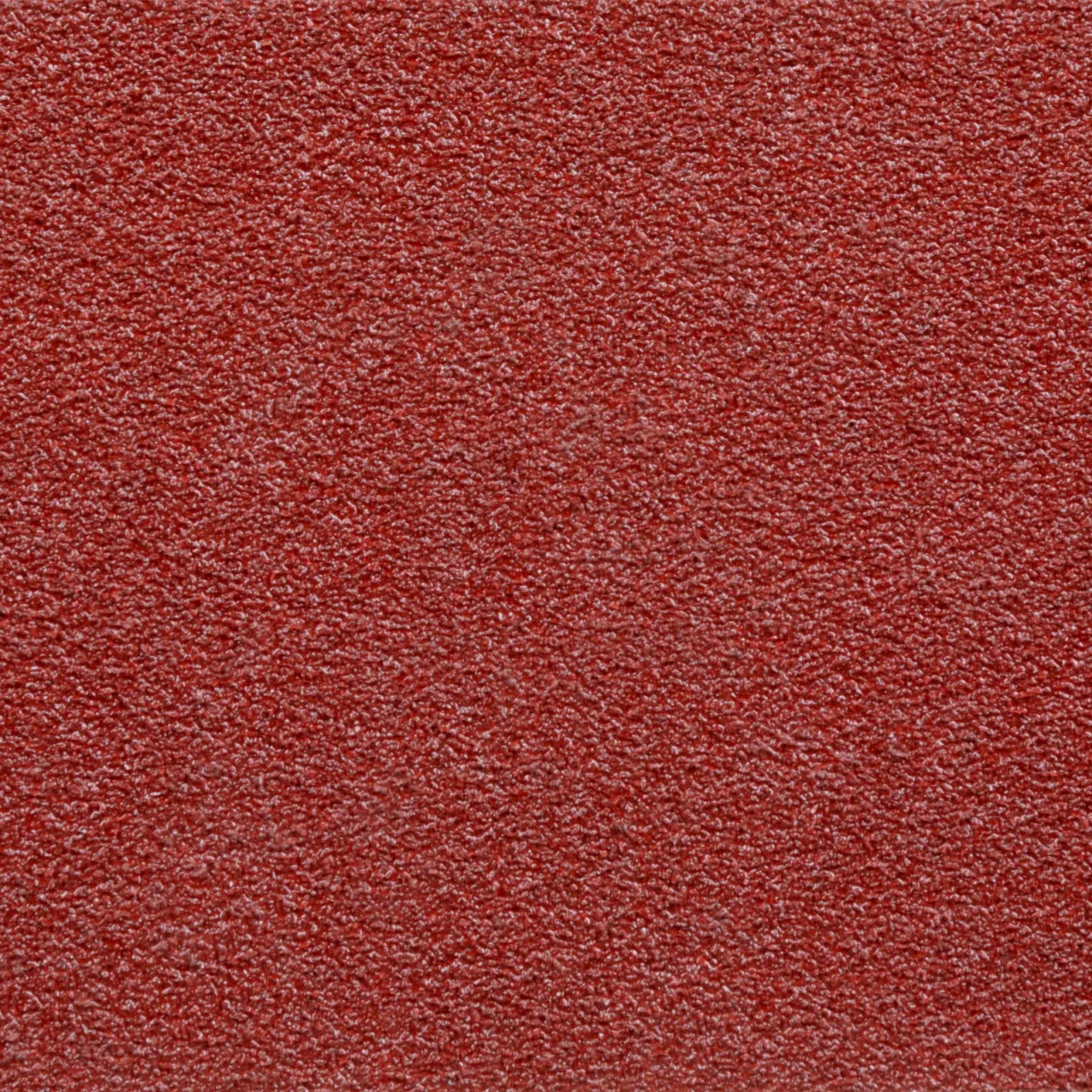 Close-up of textured red sandpaper surface.