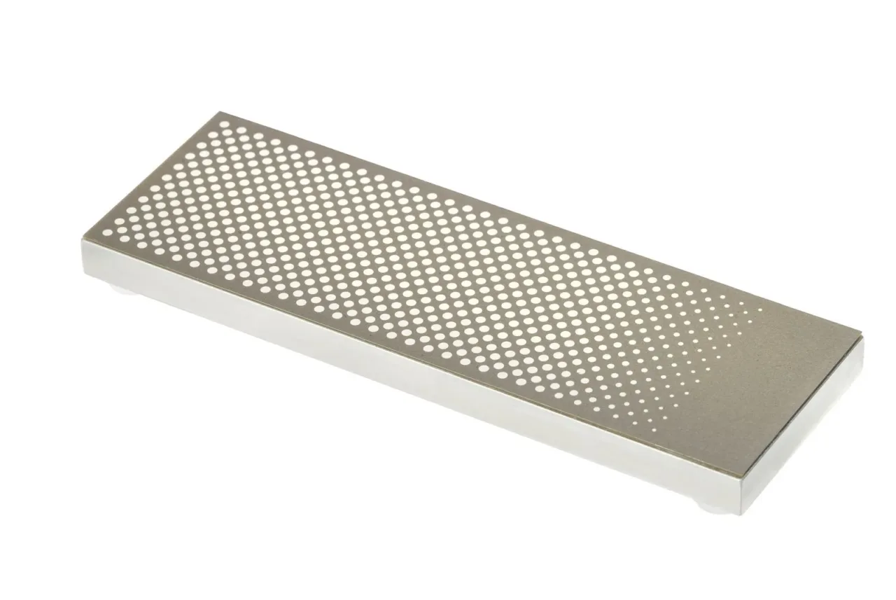 Rectangular diamond sharpening stone with holes.