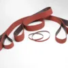 Red sanding belts on white background