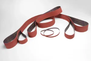 Red sanding belts on white background