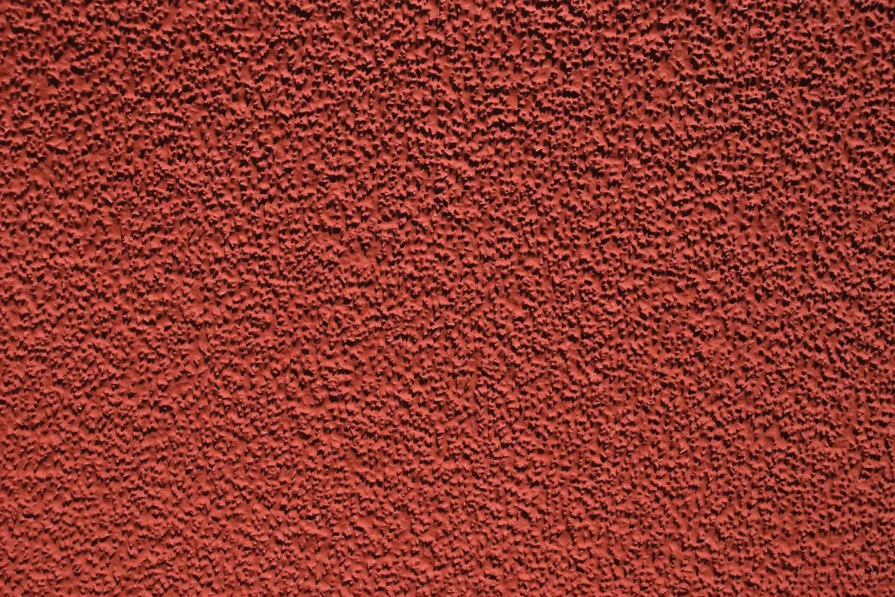 Close-up of red textured wall surface.