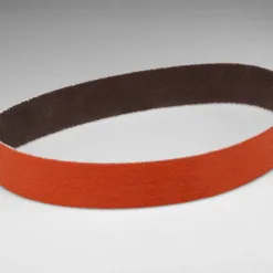 Orange abrasive sanding belt on white background.