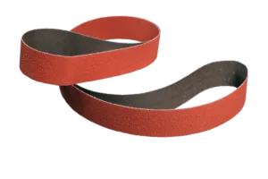 Red sanding belt twisted on white background.