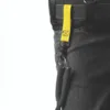 Utility belt with tool attached via yellow strap