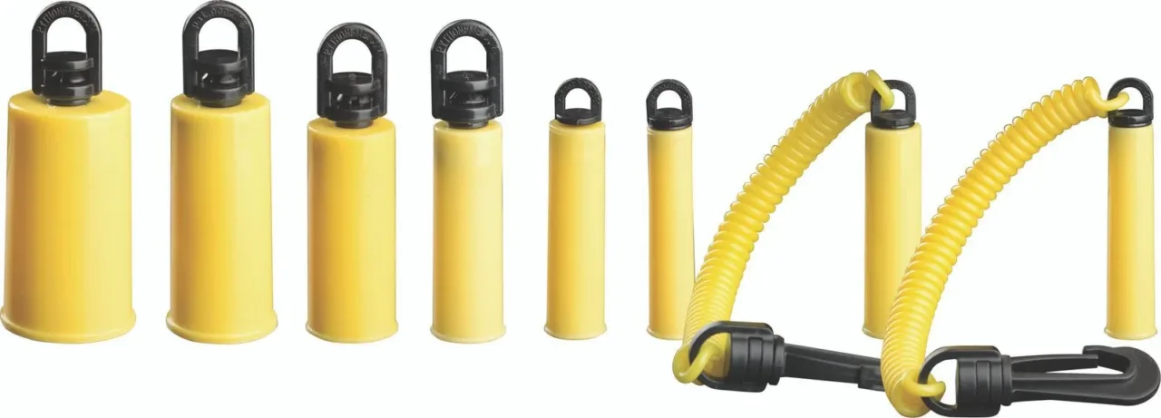 Multiple yellow bell weights with black handles.
