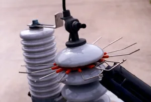 Bird-repellent spikes on electrical insulator equipment.