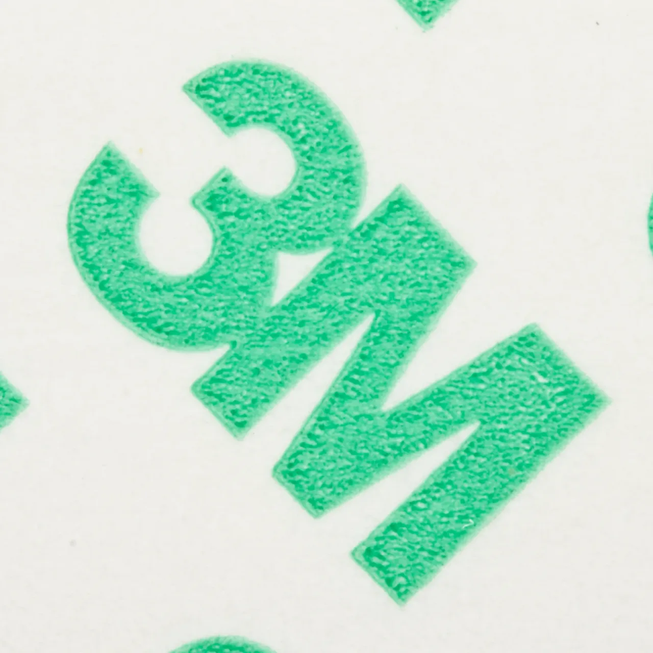 Close-up of green 3M logo on white background.