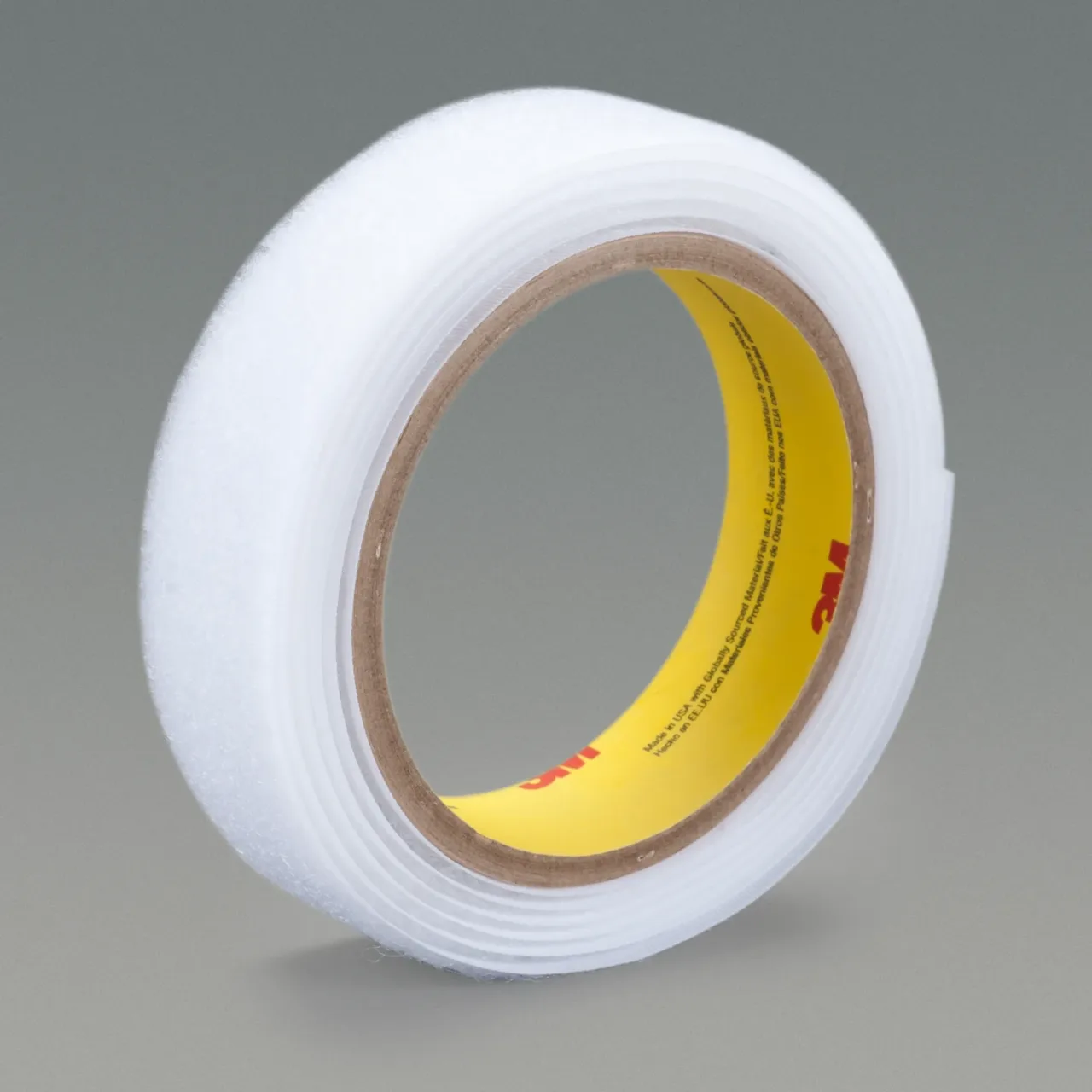 Roll of adhesive tape on gray background.