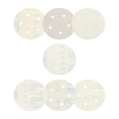 Round sanding discs with holes on white background.