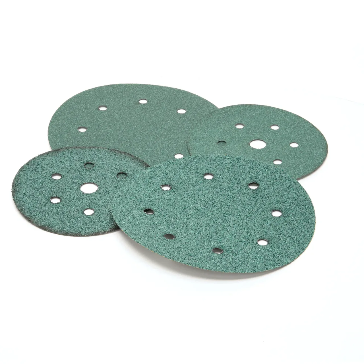 Green round sandpaper with holes on white background.