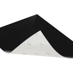 Black adhesive sheet with one corner lifted