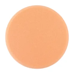 Round orange foam sponge close-up.