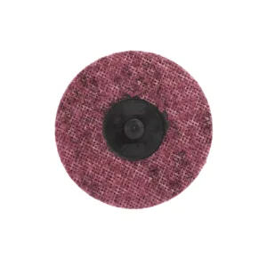 Grinding wheel with a textured pink surface.