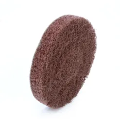 Brown abrasive cleaning pad on white background.