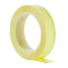 Roll of yellow adhesive tape on white background.