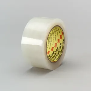 Clear adhesive tape roll on gray background.