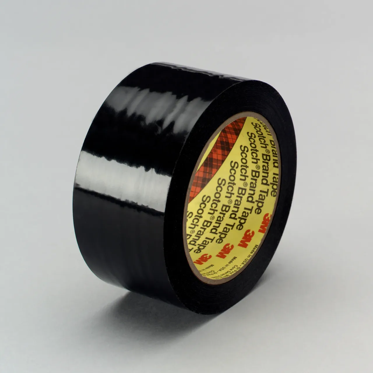 Black electrical tape roll on gray background