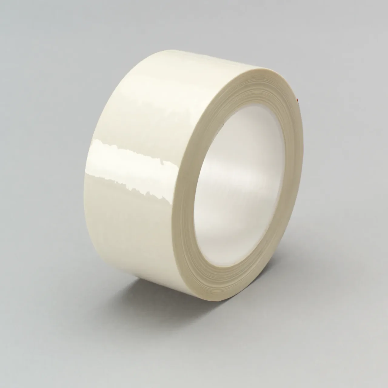 Clear adhesive tape roll on gray background.