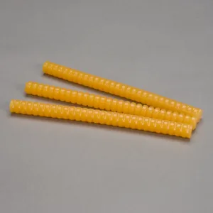Four yellow ribbed plastic dowels on gray background.