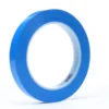 Blue roll of adhesive tape on white background.