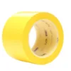 Yellow adhesive tape roll, industrial use.