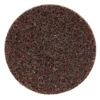 Brown circular scrubbing pad for cleaning surfaces.