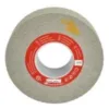 Circular grinding wheel with red label and arrow