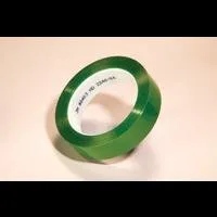 Green adhesive tape roll on beige background.