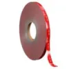 Roll of red adhesive tape with brown core.