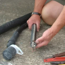 Person preparing electrical cable for installation.