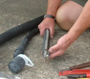 Person preparing electrical cable for installation.