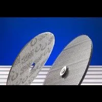 Two industrial cutting discs on blue background.