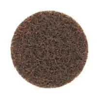 Brown circular abrasive pad for cleaning surfaces.