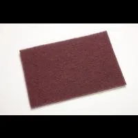 Brown abrasive scrubbing pad on white background.