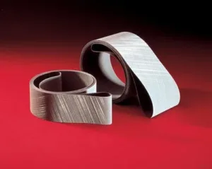 Two coiled sanding belts on red background.